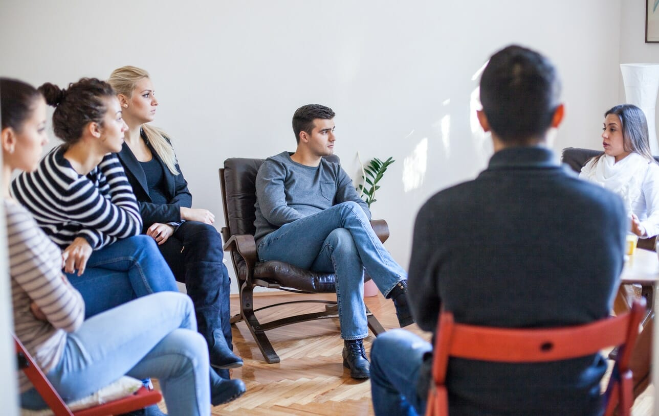 Woman speaking in group therapy session