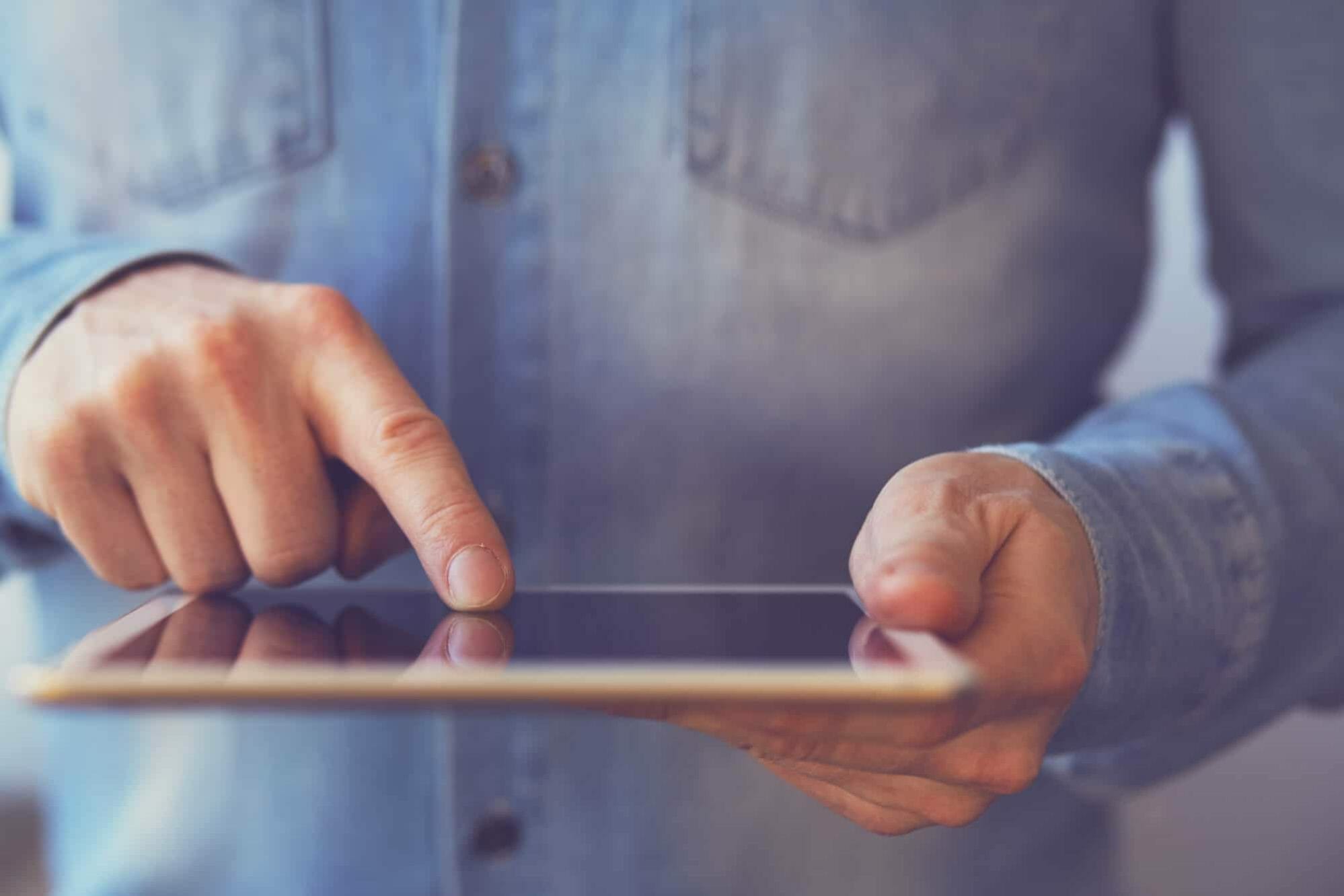 Man touching digital tablet, view close up. Toned