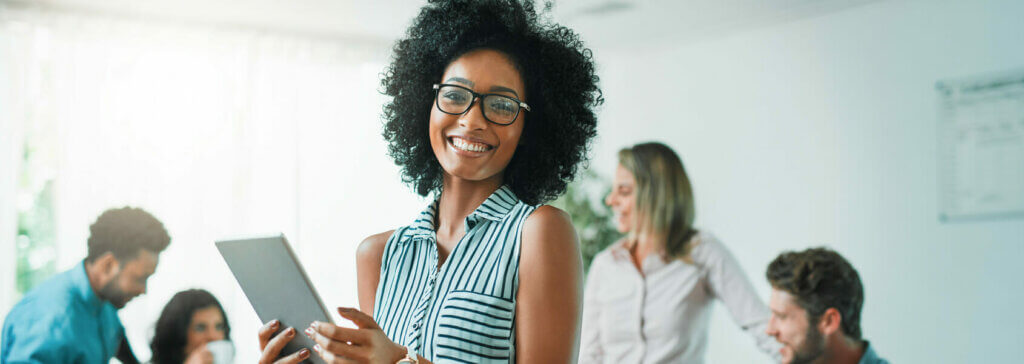 woman holding a tablet preparing to watch a qualifacts webinar