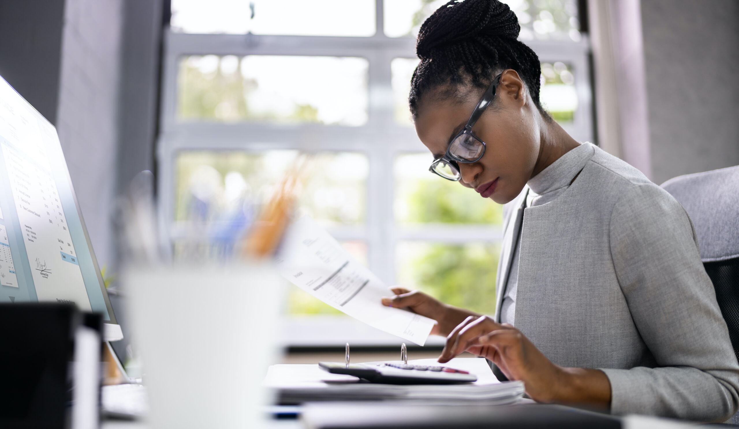 African American Accountant Or Auditor With Calculator