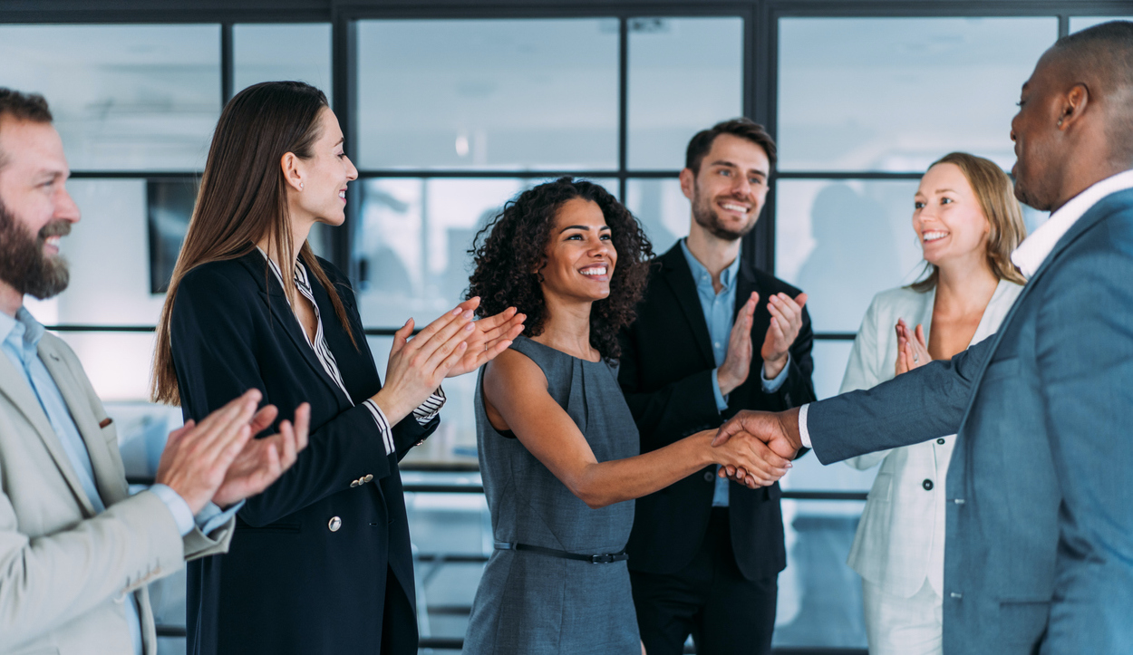 OnCall Health business people shaking hands in the office.