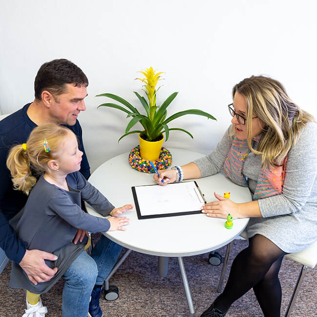 ccbhc therapist with a child patient and her father