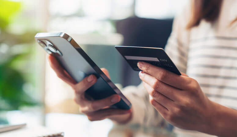 A women entering a credit card into her phone