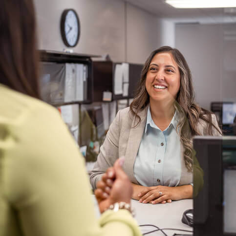 A women smiling behind a counter