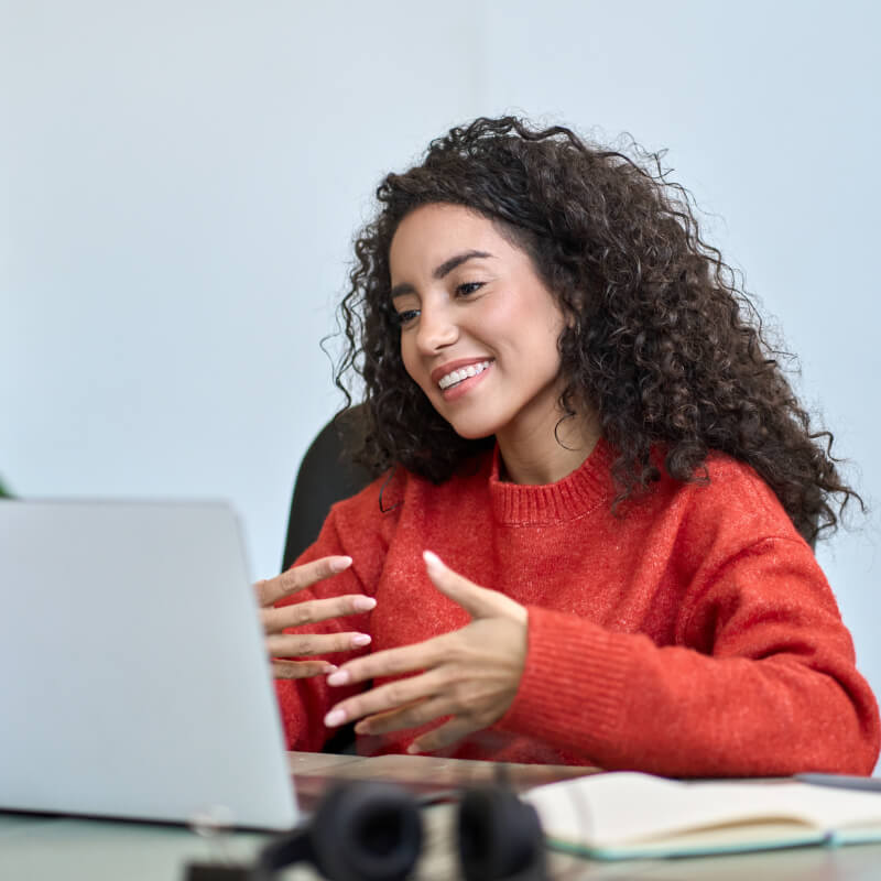 Happy latin business woman having video call hybrid meeting in office.