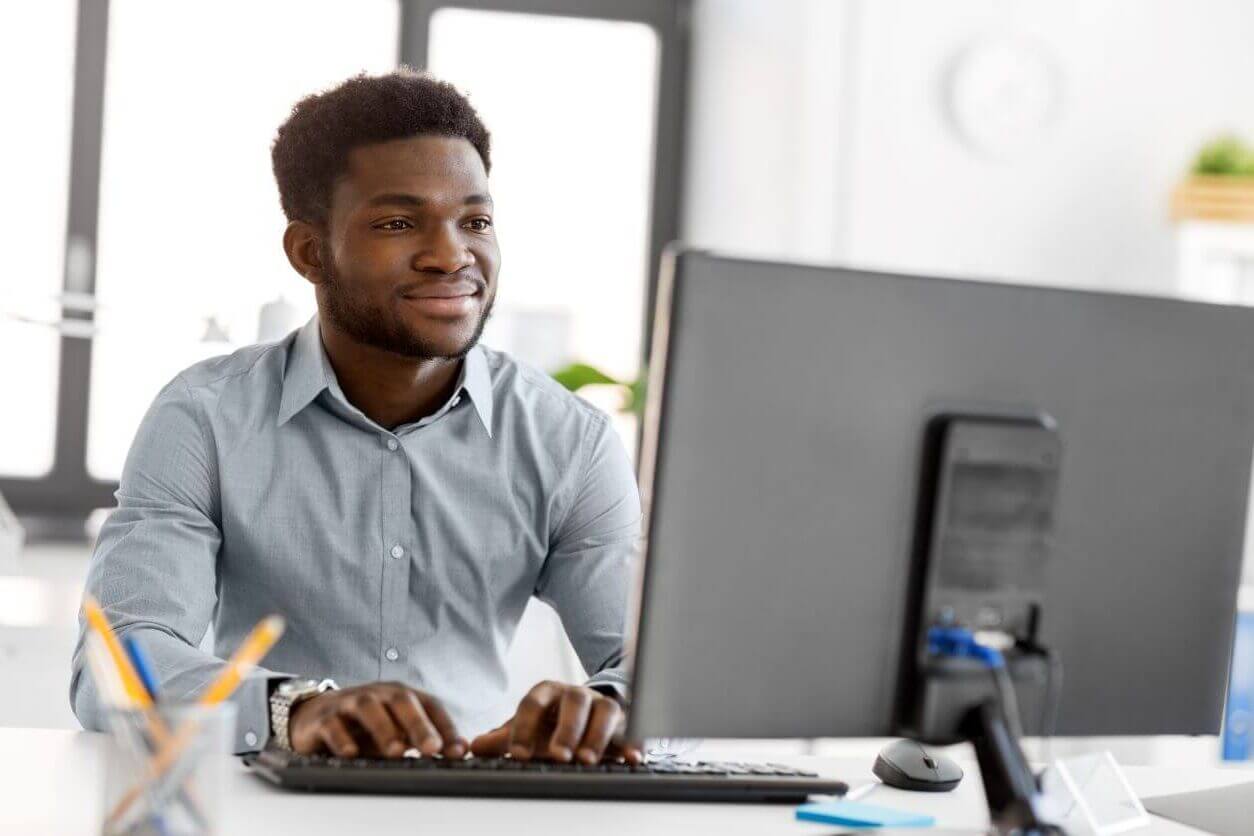 A man using a computer and typing