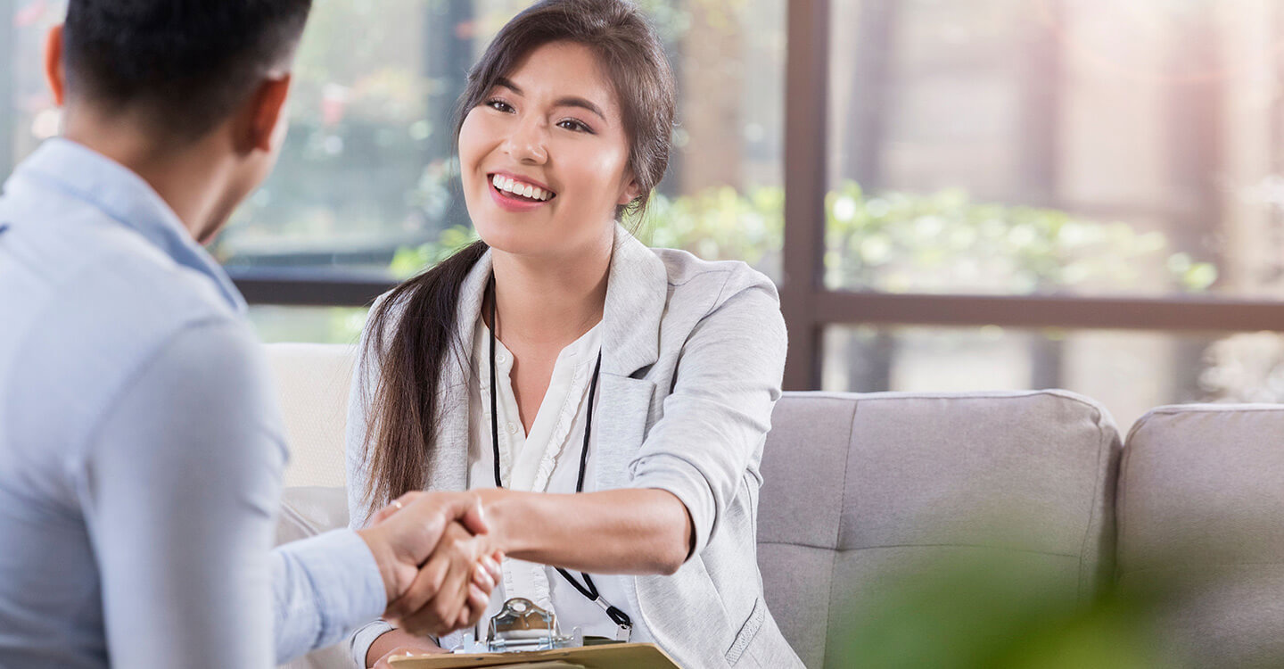 A woman and man shaking hands