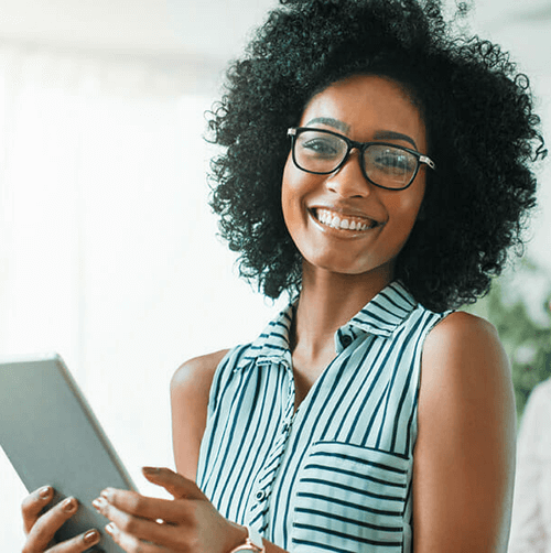 A women smiling while holding a tablet