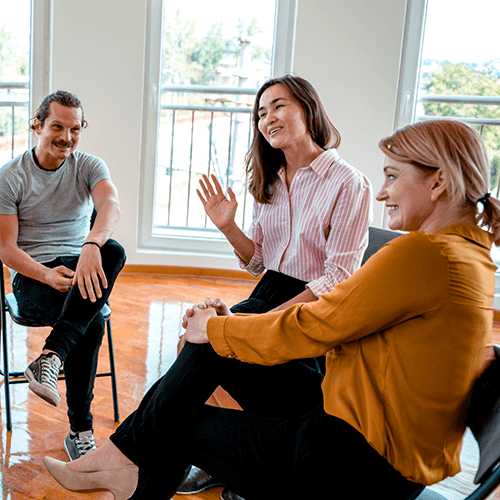 A group of people discussing in a seated circle