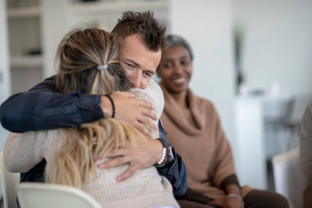 two people hugging during group therapy at a ccbhc